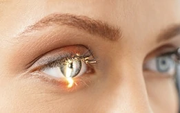 woman with blue eyes having her eye scanned