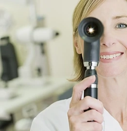 Woman holding a opthalmoscope