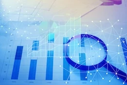 Magnifying glass and documents with analytics data lying on table