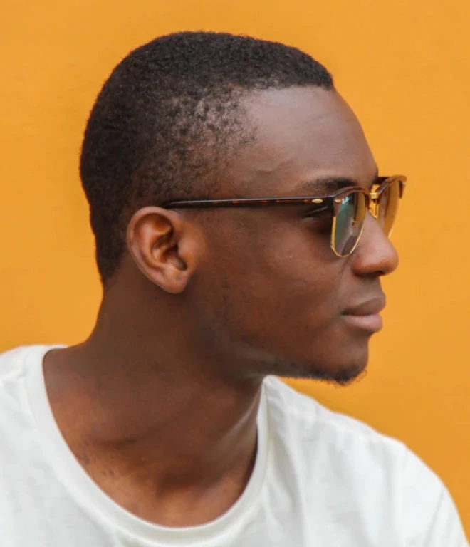 Man wearing sunglasses on orange background