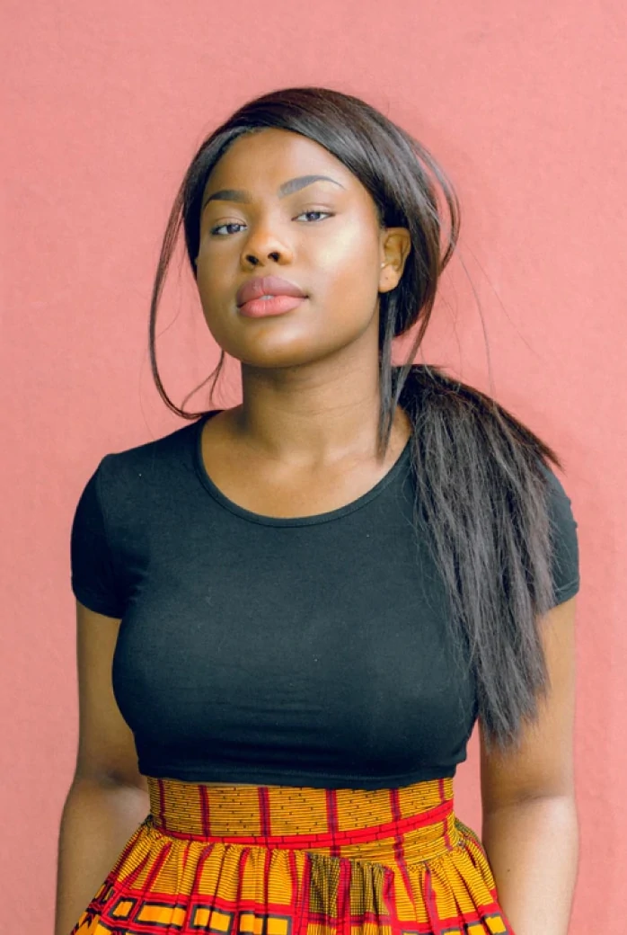 Woman wearing black shirt and yellow and red skirt