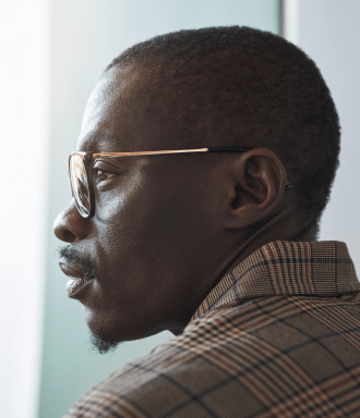Side profile of a man wearing glasses and well dressed